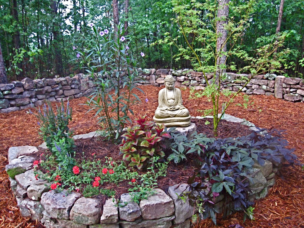 I was removing poison ivy from around a flower bed. I had two friends stop by one afternoon and they commented how nice it would be to have a stonewall behind my Buddha garden. 